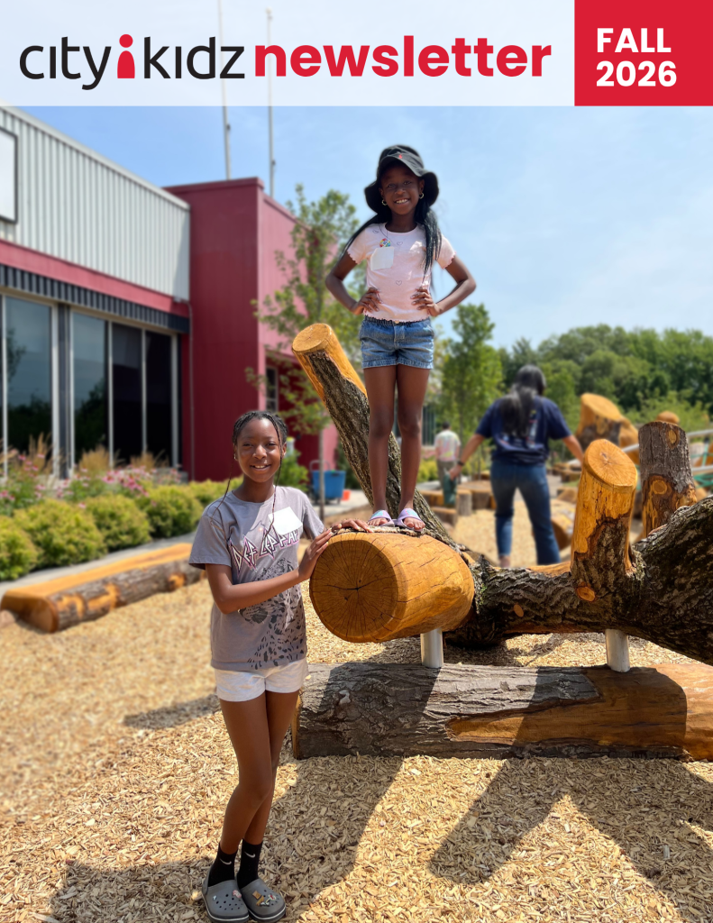 The cover of the CityKidz Newsletter featuring two children standing on a wood playground.