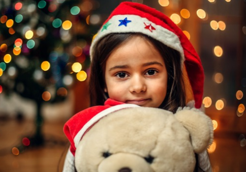 Child Holding a Stuffed Bear
